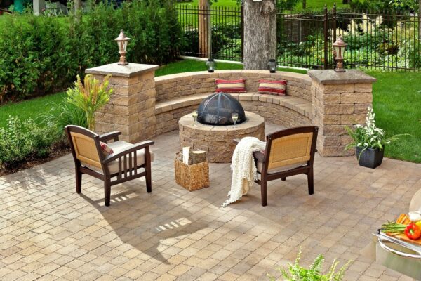 Valencia Fire Pit set up on a patio with benches and chairs