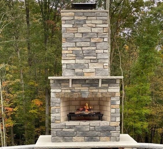 A larger, more permanent fire feature is a fireplace. Built out of paver block and stone, a fireplace can become a focal point of your outdoor living space.
